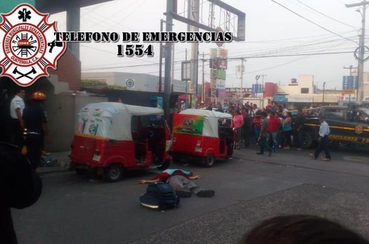 Los cadáveres de tres personas quedaron  frente a unos mototaxis, en San Miguel Petapa.  (Foto: Bomberos Municipales Departamentales)